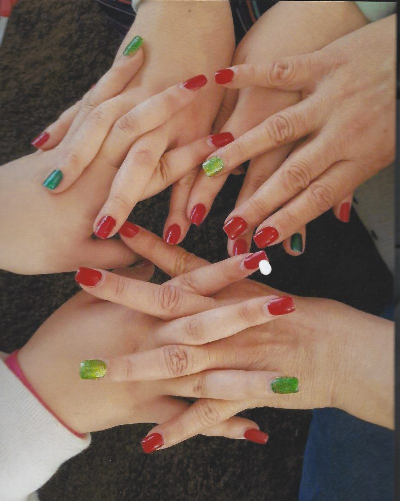 Women holding hear hands showing their nail polishes